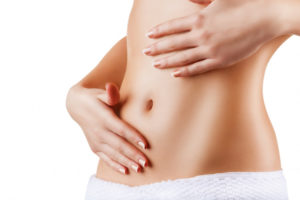 image of woman holding her abdomen