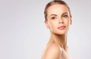 A woman looking over her shoulder, showing the results of Radiesse®