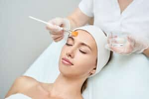 Woman relaxing as chemical peel is applied to her face in Dallas, TX