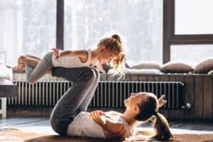 Mom and daughter doing exercises after a mommy makeover in Dallas, TX